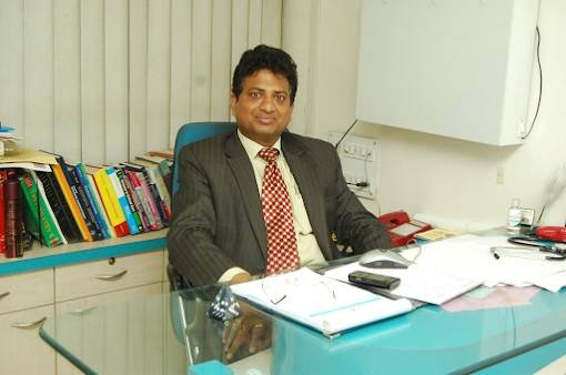 "Dr. VS Pal, a psychiatrist and neuropsychiatrist, sitting in his office surrounded by medical books and documents."