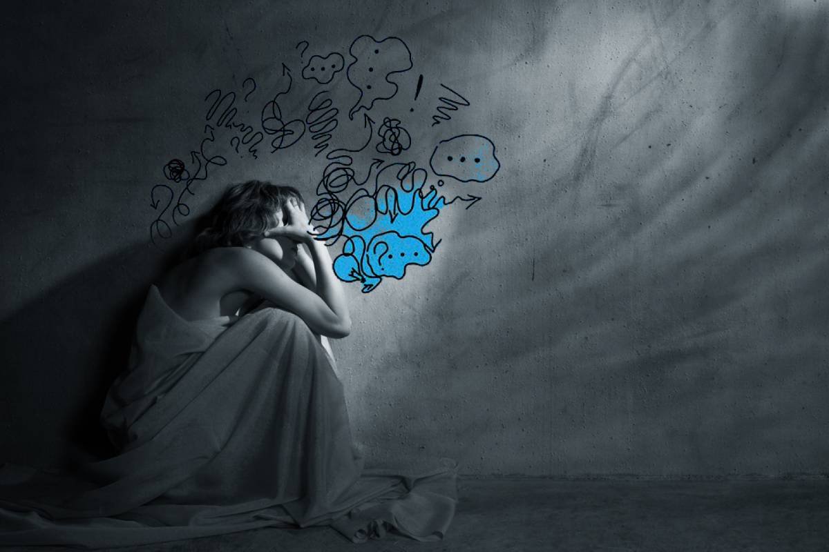 A person sitting in distress with swirling chaotic thoughts illustrated around them, symbolizing overwhelming mental and emotional struggles.